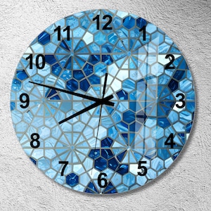 May include: A round clock with a blue and silver geometric pattern. The clock face has black numbers and hands.