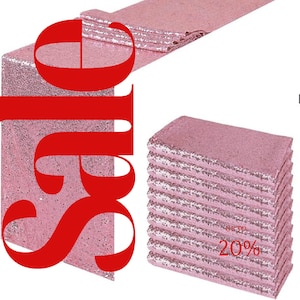 Puede incluir: Camino de mesa de lentejuelas rosa, doblado y apilado. El camino de mesa está hecho de una tela brillante y es perfecto para agregar un toque de glamour a cualquier evento. Hasta un 20% de descuento.