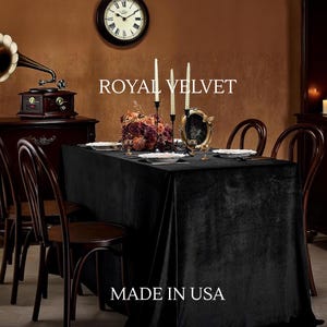May include: A black velvet tablecloth on a dining table, set for a formal dinner. White plates, candles, and a floral arrangement are on the table. The text "ROYAL VELVET" and "MADE IN USA" are displayed in the image.