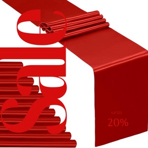 May include: Red satin table runner with the text "Up to 20%" printed on it. The runner is folded in half and the edges are visible.
