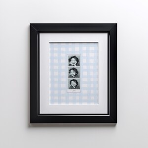 A customizable Photo Booth template, a Photo Booth strip on a blue watercolor gingham background hanging in a boys nursery or kids room.