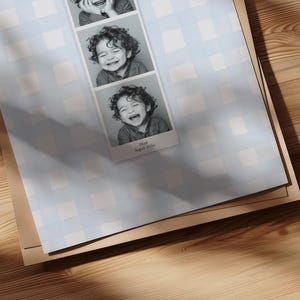 A customizable Photo Booth template, a Photo Booth strip on a blue watercolor gingham background hanging in a boys nursery or kids room.