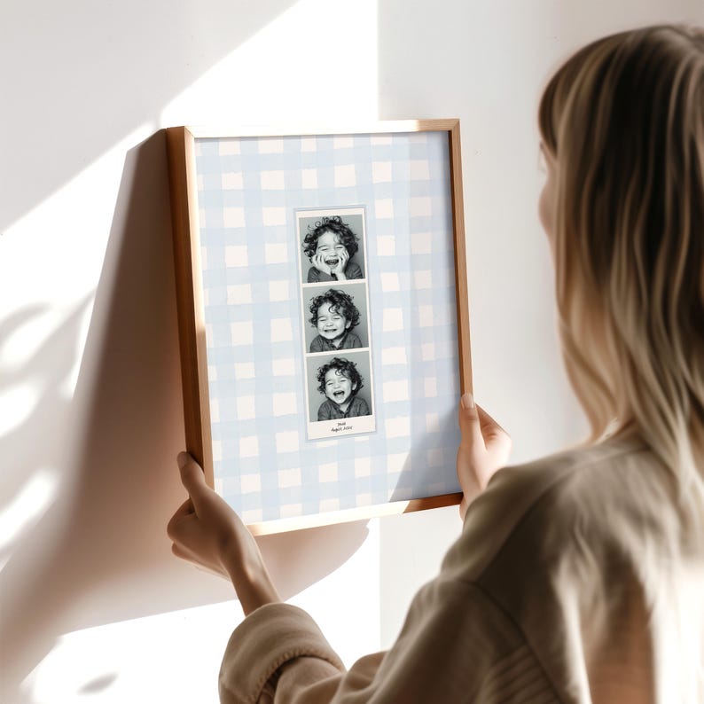 A customizable Photo Booth template, a Photo Booth strip on a blue watercolor gingham background hanging in a boys nursery or kids room.