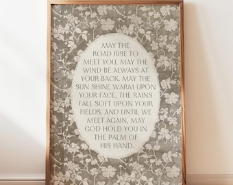 May include: A framed print with a floral background and a white oval containing a quote: "May the road rise to meet you, may the wind be always at your back. May the sun shine warm upon your face, the rains fall soft upon your fields. And until we meet again, may God hold you in the palm of his hand."