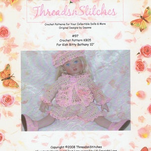 May include: A doll wearing a handmade crochet outfit, including a hat, jacket, and skirt, in shades of pink and cream. The doll is approximately 10 inches tall. The image includes text that reads "Threads n Stitches" and "Crochet Patterns".