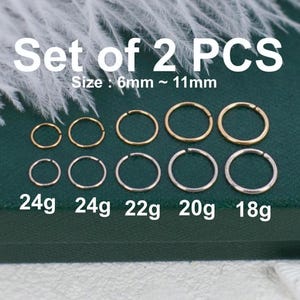 May include: A set of 2 PCS hoop rings in gold and silver tones, ranging in size from 6mm to 11mm. The rings are labeled with gauges 24g, 22g, 20g, and 18g. The text Set of 2 PCS and Size : 6mm ~ 11mm is clearly visible above the jewelry items.
