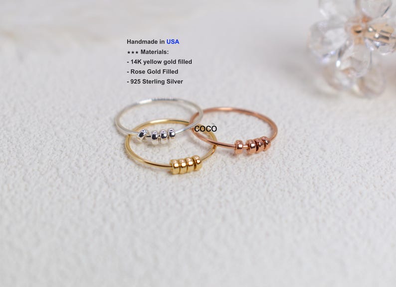 May include: Three delicate rings in silver, gold, and rose gold, each adorned with small, evenly spaced beads. The rings are handmade in the USA and are made of 14K yellow gold filled, rose gold filled, and 925 sterling silver.