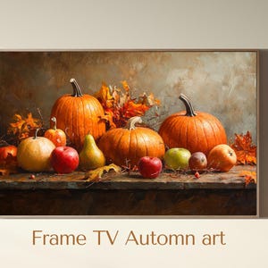 Peut inclure: Peinture encadrée d'une nature morte automnale. Elle représente des citrouilles orange, des pommes rouges et des poires jaunes, avec des feuilles d'automne. Le texte "Frame TV Autumn art" est visible.