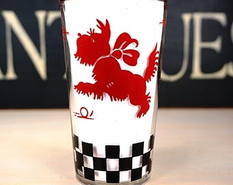 May include: A red and white glass with a black and white checkered pattern at the bottom. A red silhouette of a dog is printed on the glass.