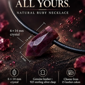 May include: A natural ruby necklace featuring a 6 x 14 mm crystal pendant on a leather cord. The text reads: ONE POINT. ALL YOURS. NATURAL RUBY NECKLACE. 6 x 14 mm crystal. Genuine leather, 925 sterling silver clasp. Choose from 15 leather colors.