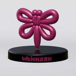 May include: A magenta butterfly sculpture with rounded wings and body, mounted on a black circular base. The base features the text "LOLICHARM" in magenta. The sculpture has a smooth, glossy finish.