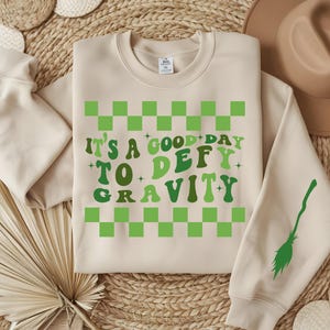 Defying gravity Sweatshirt, wicked shirt, elphaba shirt, cute witch shirt, wicked crewneck, wicked movie shirt, musical lovers shirt wicked