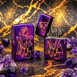 May include: Three purple lighters with a metallic finish, featuring a gold-colored graphic design. One lighter is open, revealing the interior. Amethyst crystals surround the lighters, set against a dark background with gold accents.