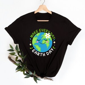 May include: Black t-shirt with a green and blue cartoon Earth with a smiling face and a white flower. The text "Make Every Day Earth Day" is written around the Earth.