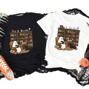 a couple of t - shirts sitting on top of a table