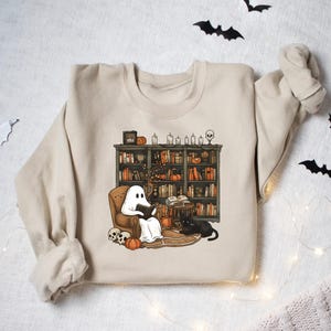 a sweater with a ghost and a dog on it