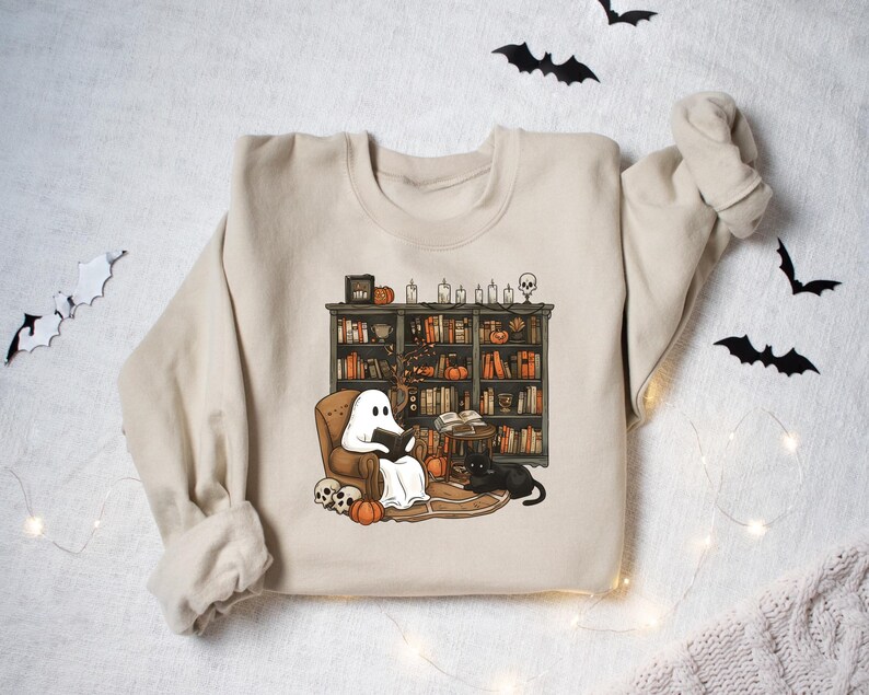 a sweater with a ghost and a dog on it