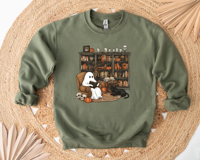 a green sweatshirt with a dog and a cat on it