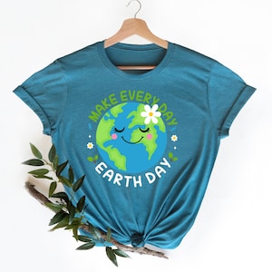 May include: Teal blue t-shirt with a graphic of a smiling cartoon Earth with a flower on top. The text "Make Every Day Earth Day" surrounds the Earth graphic.