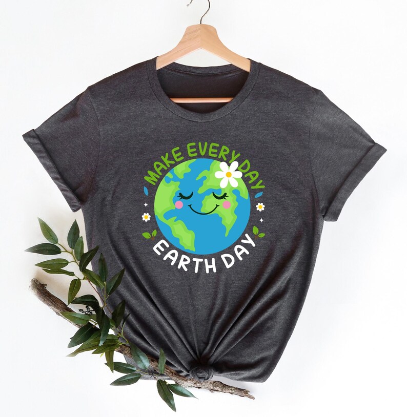 May include: A dark gray t-shirt with a graphic of a smiling cartoon Earth with a flower on top. The text "Make Every Day Earth Day" surrounds the Earth graphic.