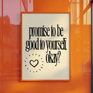 May include: An orange framed print with the text "promise to be good to yourself, okay?" in black. A black heart with radiating lines is below the text. The print is hanging on an orange wall.