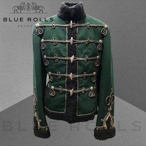 May include: A green military-style jacket with gold trim and black fur lining. The jacket has a high collar and multiple rows of buttons. The jacket is labeled "BLUE ROLLS BESPOKE".