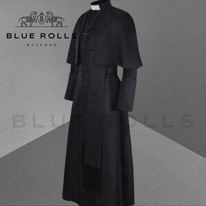 May include: A black cassock with a cape, a white collar, and a black sash. The cassock has a row of buttons down the front and a cross on the chest.