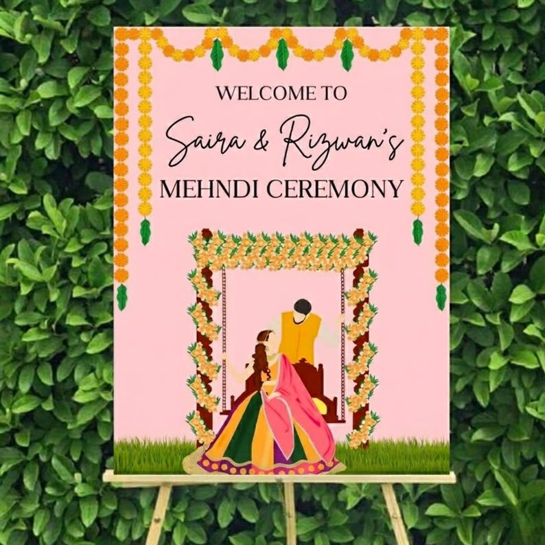 May include: A pink sign with the words "WELCOME TO Saira & Rizwan's MEHNDI CEREMONY" in black script. The sign features a floral arch and a couple in traditional attire, with a green leafy background.