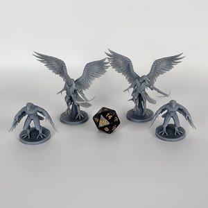 May include: Four grey 3D printed miniatures of bird-like creatures with wings, one with a black 20-sided die in the center.