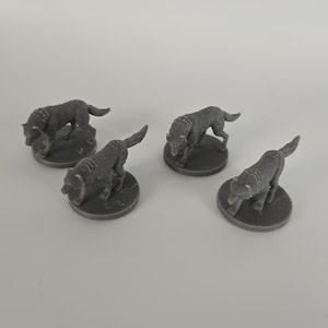 May include: Five gray miniature wolf figurines, each standing on a small, round base. The wolves are in various poses, some with their heads down and others looking forward. The figurines are made of a solid, matte material.