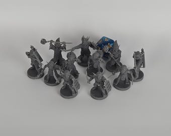 May include: A collection of eleven unpainted gray plastic miniature fantasy figures in various combat poses, each standing on a circular base. One blue twenty-sided die is positioned among the figures, which are armed with swords, shields, and staves.