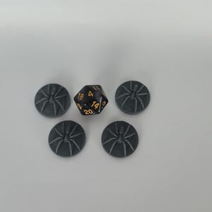 May include: Five gray plastic spider tokens and a black twenty-sided die with gold numbers.