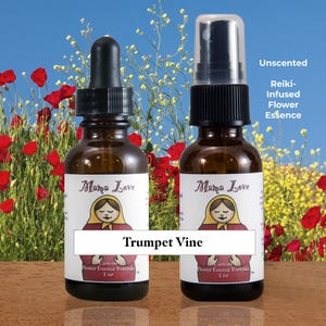 May include: Two brown glass bottles of Mama Love flower essence. One has a dropper, the other a spray top. The labels feature a Matryoshka doll design and the text "Trumpet Vine". The background shows red poppies and a blue sky.