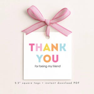 May include: A white square tag with a pink ribbon bow at the top. The tag features the words "THANK YOU" in colorful block letters, with the phrase "for being my friend" below. The tag is 2.5 inches square.