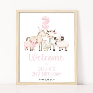 May include: A pink and white welcome sign for a 2nd birthday party. The sign features a pig, a cow, a horse, and a chicken. The text on the sign reads "Welcome to Olivia's 2nd Birthday 15 March 2025".