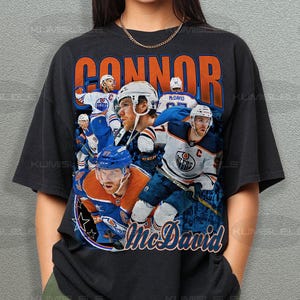 May include: Black t-shirt with a vintage-style graphic of hockey player Connor McDavid and the text "Connor McDavid".