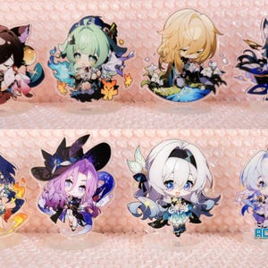 May include: Eight colourful anime character acrylic stands. The characters are all female and have different hair colours, outfits, and accessories. The stands are clear and have a white background. The text "ACGCrafts" appears in the bottom right corner of the image.