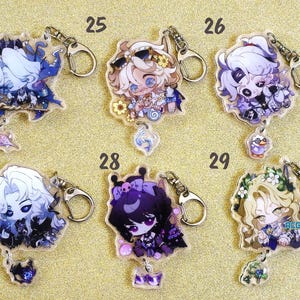 May include: Ten colorful character keychains with silver key rings. Each keychain features a different anime character with a unique design and color scheme. The keychains are arranged in two rows of five, with numbers 24, 25, 26, 27, 28, and 29 printed above each keychain.