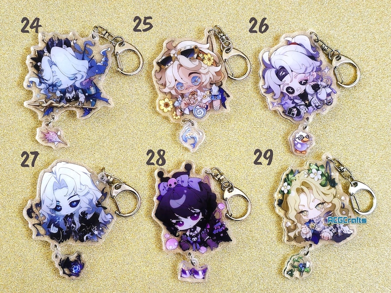 May include: Ten colorful character keychains with silver key rings. Each keychain features a different anime character with a unique design and color scheme. The keychains are arranged in two rows of five, with numbers 24, 25, 26, 27, 28, and 29 printed above each keychain.