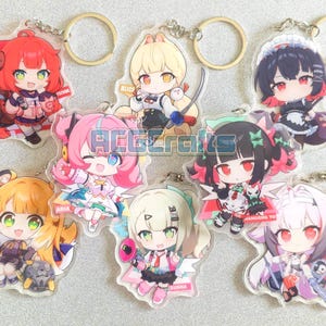 May include: A selection of anime-style acrylic keyrings showcasing colourful chibi characters. Each keyring has a gold-coloured ring and a detailed illustration of a character with unique outfits and accessories. The keyrings are designed with vibrant colours and intricate details.