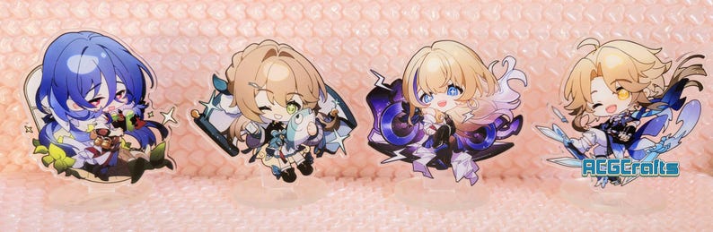 May include: Four anime-style character stickers with colourful designs. The characters are depicted in a chibi style with large eyes and bright colours. The stickers are printed on clear vinyl and have a glossy finish.