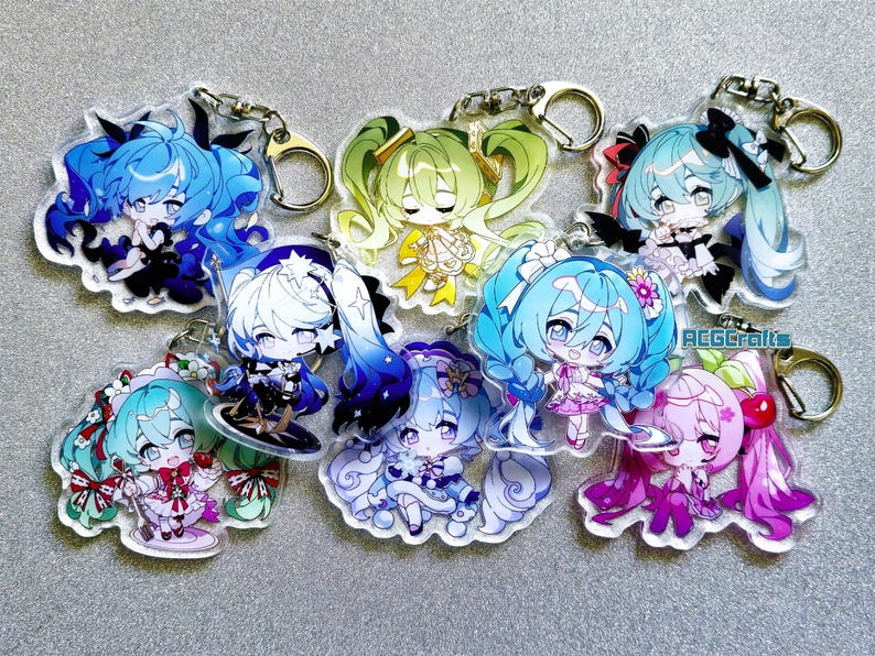 May include: A set of eight colorful anime character keychains. Each keychain features a different character with a unique design and color scheme. The keychains are made of clear acrylic and have a metal ring for attaching to keys or bags.