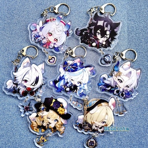 May include: Seven colorful anime character keychains with gold key rings. Each keychain features a different character with a unique design and color scheme. The keychains are made of clear acrylic and have a glossy finish.