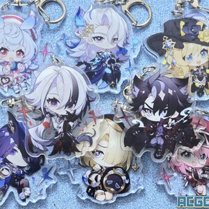 May include: A set of eight colorful anime character keychains with glitter accents. The keychains are made of clear acrylic and feature various characters with different poses and expressions. The keychains are attached to silver metal key rings.