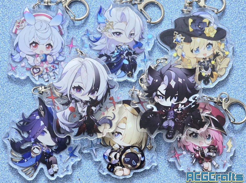 May include: A set of eight colorful anime character keychains with glitter accents. The keychains are made of clear acrylic and feature various characters with different poses and expressions. The keychains are attached to silver metal key rings.