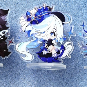 May include: Three anime character acrylic stands. The characters are depicted in a chibi style. The first character is a male with black hair and a black and red outfit. The second character is a female with white hair and a blue and white outfit. The third character is a male with white hair and a blue and black outfit. The stands are on a blue background. The text "ACGCrafts" is visible in the bottom right corner of the image.
