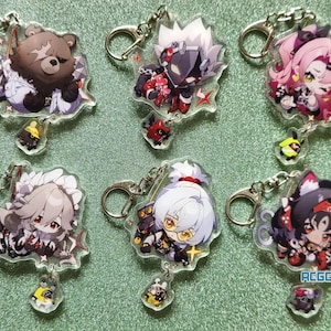 Op de afbeelding: Set van tien kleurrijke anime-personage sleutelhangers. Elke sleutelhanger heeft een ander personage met een uniek ontwerp. De sleutelhangers zijn gemaakt van helder acryl en hebben een metalen ring om aan sleutels of tassen te bevestigen.