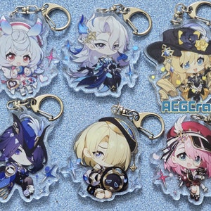 May include: Six colorful anime character keychains with glitter accents. Each keychain features a different character with a unique design and pose. The keychains are made of clear acrylic and have a silver metal ring.