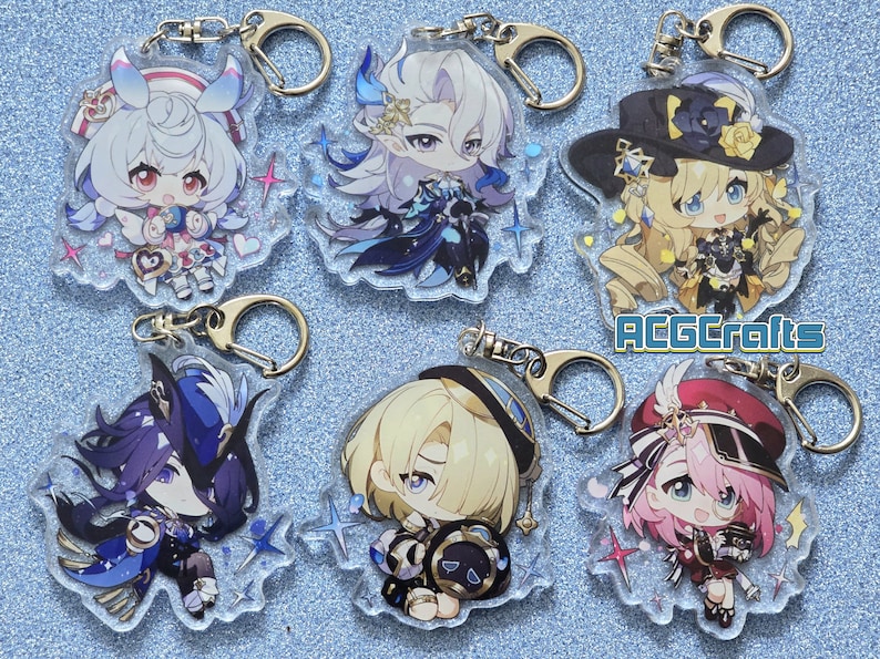 May include: Six colorful anime character keychains with glitter accents. Each keychain features a different character with a unique design and pose. The keychains are made of clear acrylic and have a silver metal ring.