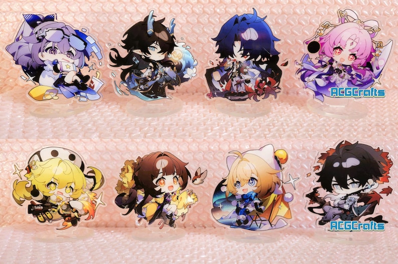 May include: Set of ten anime character acrylic charms. The charms feature various characters with different coloured hair and clothing. The charms are all in a cartoon style and have a glossy finish.